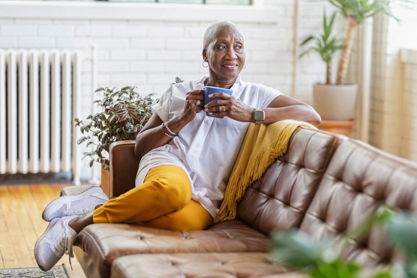 Woman sitting on a couch, holding a mug